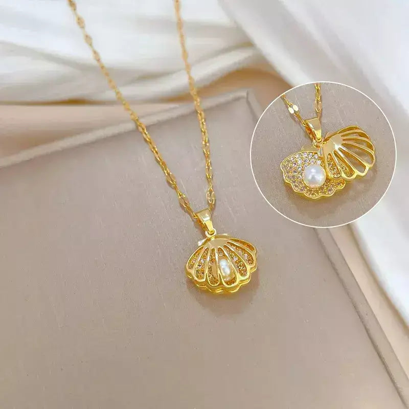seashell pearl necklace, women’s seashell and pearl necklace, zirconia seashell necklace, elegant seashell necklace, modern pearl necklace, sophisticated women’s necklace, gift necklace for her, elegant beach style seashell necklace, women’s pearl jewellery, delicate seashell pendant necklace, luxury women’s necklace, pearl zirconia necklace gift, stainless steel women’s necklace, birthday gift necklace for women, necklace symbol of protection and love