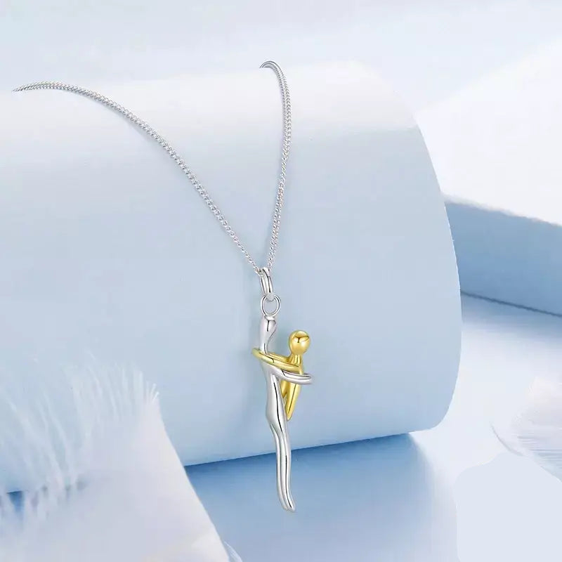 Mother & Child Necklace,

925 Sterling Silver Necklace,

Mother’s Day Gift Necklace,

Sterling Silver Hug Pendant,

Two-tone Silver and Gold Necklace,

Family Bond Necklace,

Sentimental Jewellery for Mum,

Mom and Child Jewellery,

Meaningful Jewellery for Mum,

Keepsake Necklace for Mum